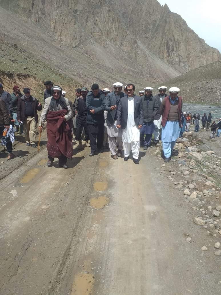 Officials standing in formal line at mountain ceremony
