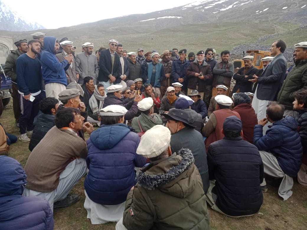 Large community jirga gathering at a high mountain pass near Shandur