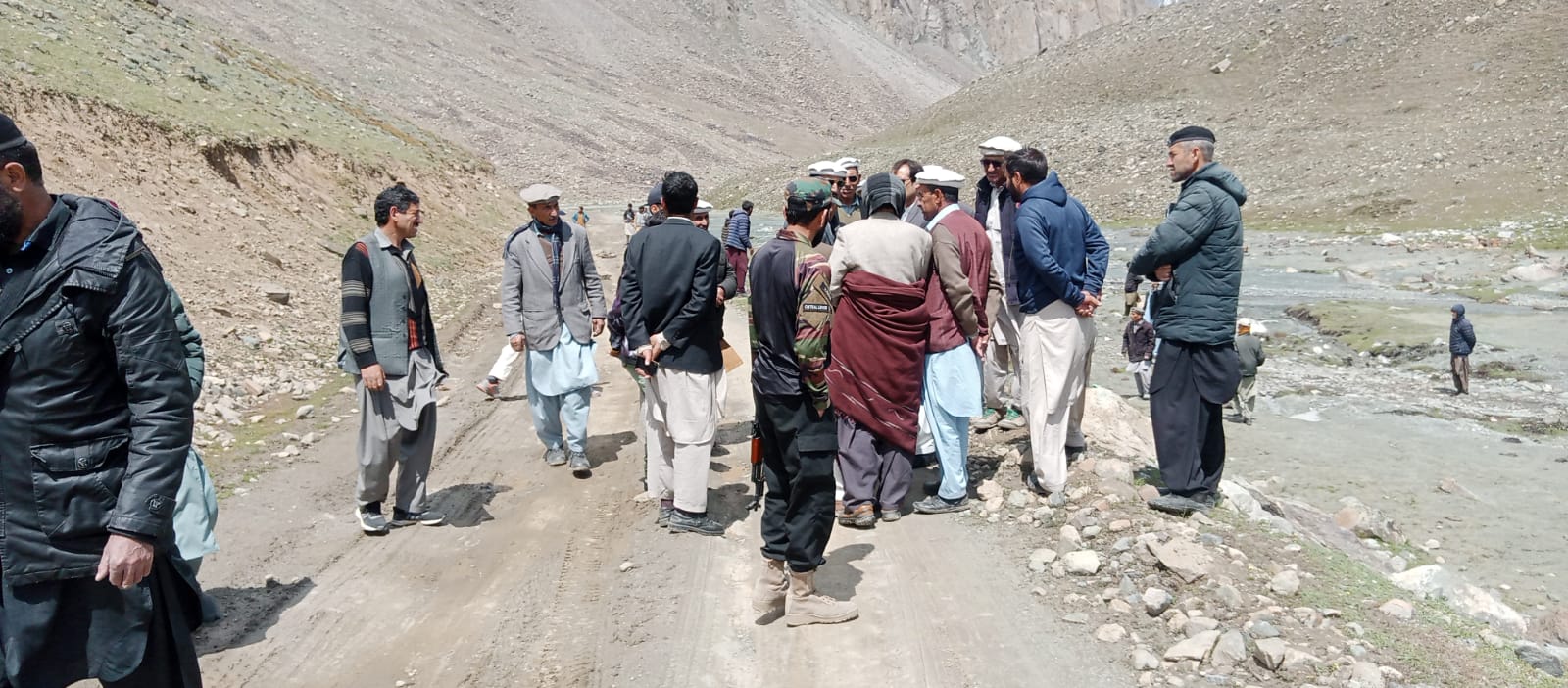 Community members discussing on a mountain road in the highlands of Chitral