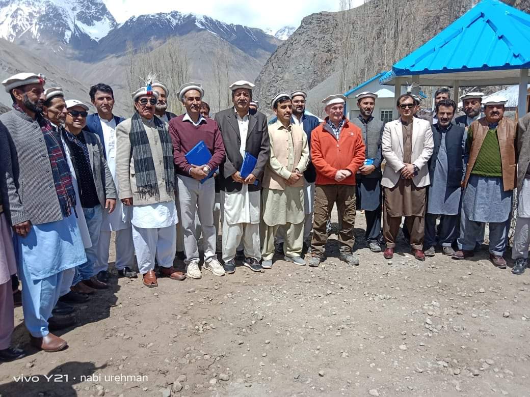 Officials and dignitaries walking in mountain valley