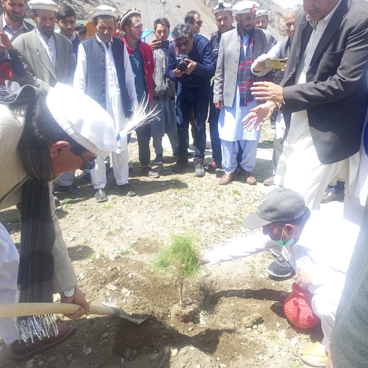 Officials signing documents at outdoor ceremony