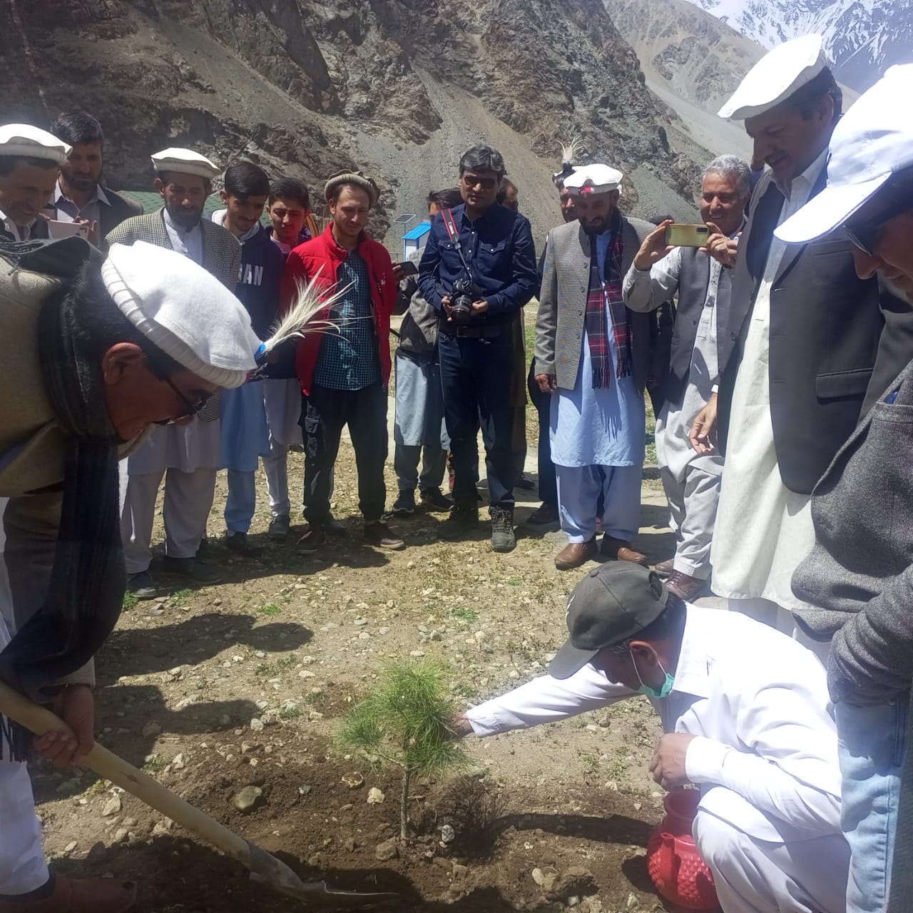 Tree-planting ceremony with community members in the mountains of Chitral
