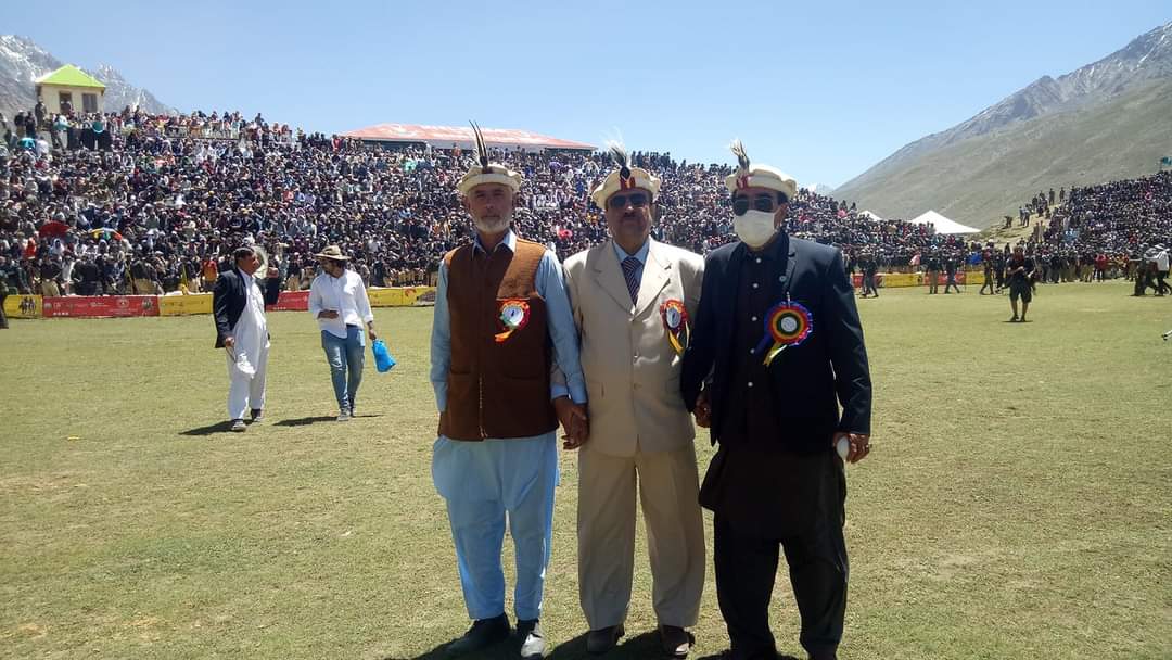 Freestyle polo action at Shandur with riders charging through mountain valley