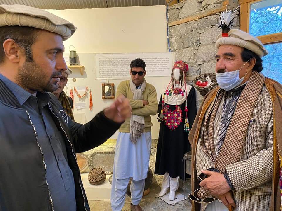 Museum guide explaining traditional Chitrali cultural exhibits inside the Heritage Museum