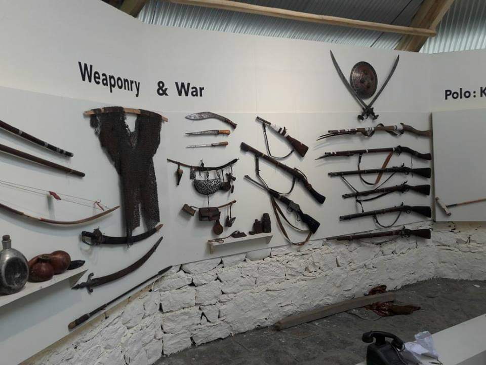 Museum wall display of weapons and war artifacts