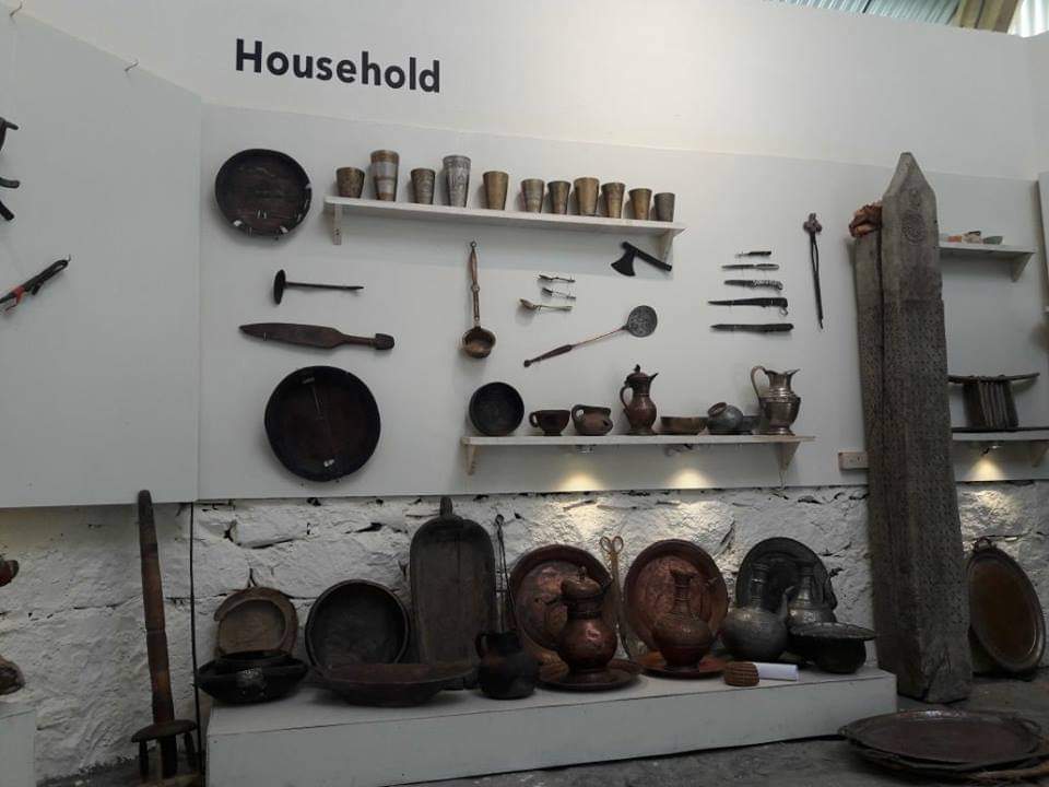 Ornate shield and rifles displayed on museum wall