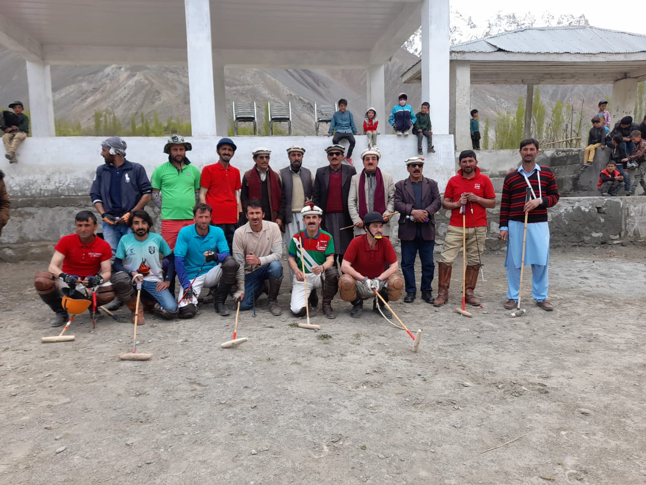 Large group of polo players with mallets at community event