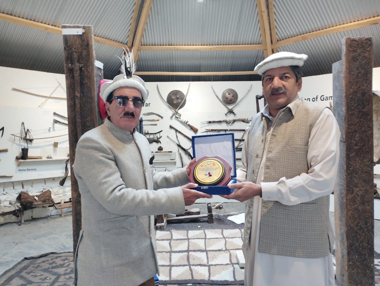 Yaftali receiving an award inside the Laspur Heritage Museum